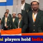 Pakistani chess players celebrate Indian victory holding the tricolour